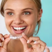 Smiling Woman With Beautiful Smile Using Teeth Whitening Tray. High Resolution Image