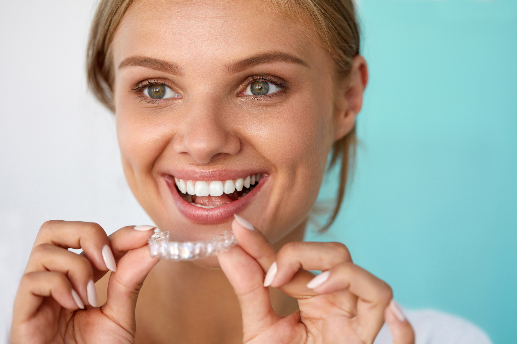 Smiling Woman With Beautiful Smile Using Teeth Whitening Tray. High Resolution Image